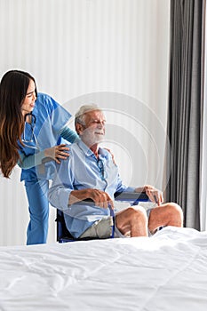 Caregiver nurse take care a Senior patient sit on wheelchair. Nurse helping senior Man