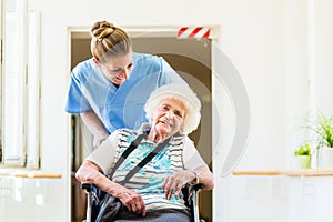 Caregiver with senior patient in wheel chair