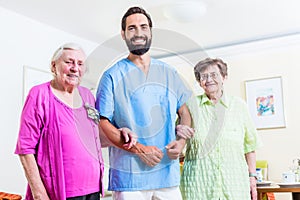 Caregiver with senior women in nursing home