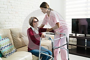 Caregiver Supporting Senior Disabled Patient At Home photo