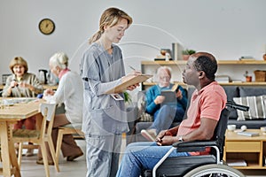 Caregiver talking to man with disability