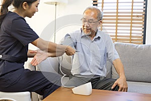 Caregiver Therapist doctor examining an older man use blood pressure