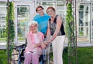 Caregivers for Elderly Patient at Home Garden. photo