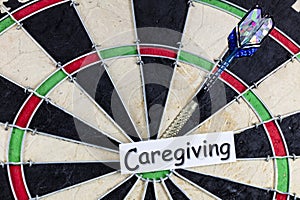 Caregiving senior caregiver help elderly health elder care support dartboard game photo