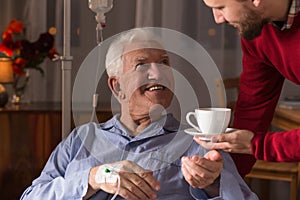 Carer assisting incurable ill man photo