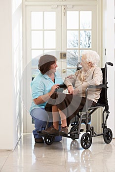 Carer With Disabled Senior Woman