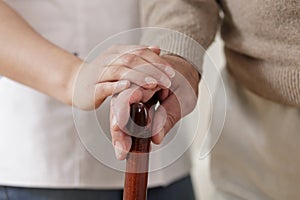 Carer holding old man hand