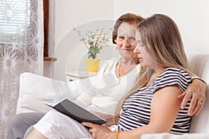 Carer spending time with an elderly woman
