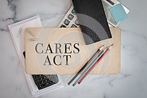 CARES ACT wooden sign office business supplies pencils calculators flat lay background photo