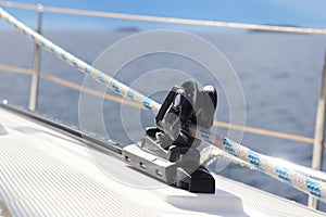 Caretail of a staysaillet on a sailing yacht for sending tracks against the background of the summer sea. Outfit of a sailing yach