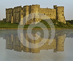 Carew Castle Pembrokeshire reflected in the Millpond