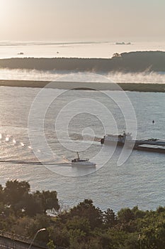 Cargo barge DMITRIY KALININ and Ship DONARIS 2 on the Danube river early in the