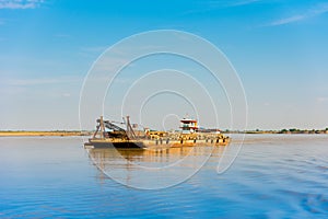 Cargo barge on the Irrawaddy river, Bagan, Myanmar, Burma. Copy space for text.