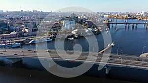 Cargo barge sailing under the Havansky bridge near Podil