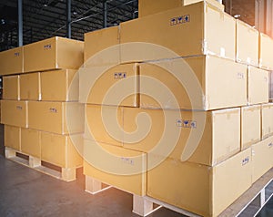 Cargo boxes shipment, Manufacturing and warehousing. Stack of cardboard boxes on pallet and hand pallet truck at warehouse storage