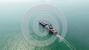 cargo container ship sailing full speed in sea to import export goods and distributing products to dealer and consumers worldwide