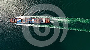 cargo container ship sailing full speed in sea to import export goods and distributing products to dealer and consumers worldwide
