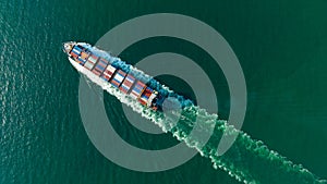 cargo container ship sailing full speed in sea to import export goods and distributing products to dealer and consumers worldwide