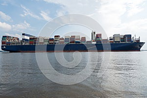 Cargo container ship sailing on the river