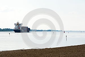 Cargo container ship sailing on the river