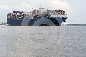 Cargo container ship sailing on the river