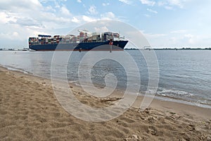 Cargo container ship sailing on the river