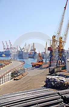 Cargo container ships and cranes at shipyard.
