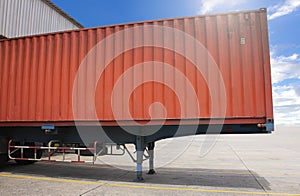 Cargo container truck loading at dock warehouse. Trailer docking stations. Industry freight truck transport.