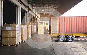 Cargo Container Truck Parked Loading at Dock Warehouse. Cargo Shipment. Industry Freight Truck Transportation.