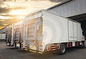 Cargo container truck parked loading at dock warehouse. Industry cargo freight shipment. Logistics and transportation.