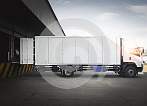 Cargo Container Trucks Parked Loading at Dock Warehouse. Shipping Cargo Trucks. Distribution Warehouse Center. Lorry Freight.