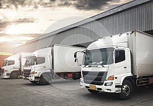 Cargo Container Trucks Parked Loading at Dock Warehouse. Shipping Warehouse Logistics.Cargo Shipment. Freight Truck Transport.