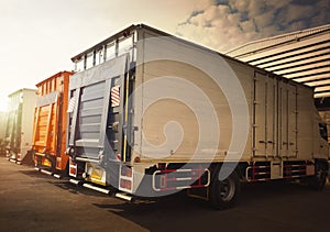 Cargo Container Trucks on Parking Lot at Distribution Warehouse. Freight Truck Logistics Cargo Transport