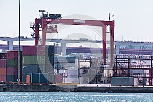 Cargo containers in the port. Marine crane lifts the cargo container. Import export transportation, logistics business, customs