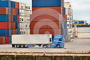 Container terminal in Rotterdam with truck in front of stack of containers