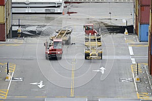 Cargo containers trucks in storage area of a freight port