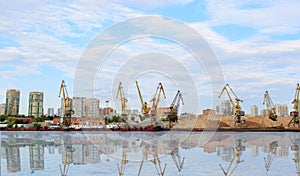 Cargo cranes in port terminal . The shore of the river Moscow.