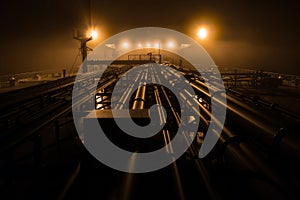 Cargo deck of tanker at night.