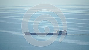 Cargo and dredging industrial ships sailing in to sea horizon. One large cargo ship grain carrier tanker in sea on sunny