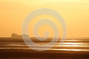 Cargo ferry ship, windfarm, sunset, Morecambe Bay