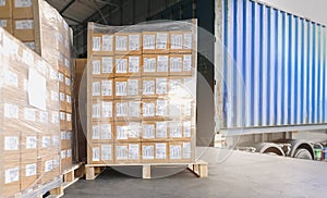 Cargo freight, Shipment, Delivery service. Warehouse docks. Stacked package boxes on pallet waiting to load into container truck.