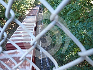 cargo freight train view from chain link fence