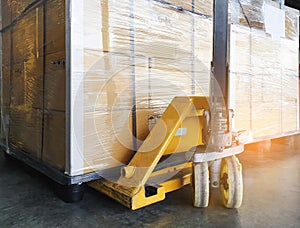 Cargo pallet shipment, Manufacturing and warehousing. Hand pallet truck with heavy cargo boxes on pallet.