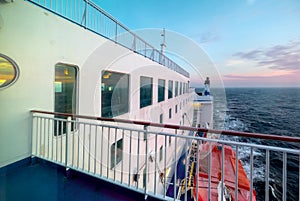 Cargo passenger ferry at sunset