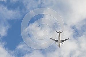 Cargo plane in the blue sky and clouds.