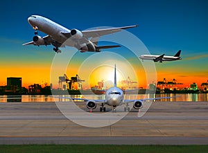 Cargo plane flying over airport against beautiful morning light