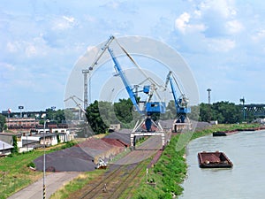 Cargo port, loading cranes, barge, bulk cargo