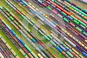 Cargo railway carriage. Aerial diagonally view from flying drone of colorful freight trains on the railway sort facility. Wagons