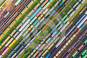 Cargo railway carriage. Aerial diagonally view from flying drone of colorful freight trains on the railway sort facility. Wagons