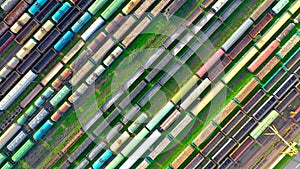 Cargo railway carriage. Aerial diagonally view from flying drone of colorful freight trains on the railway sort facility. Wagons w